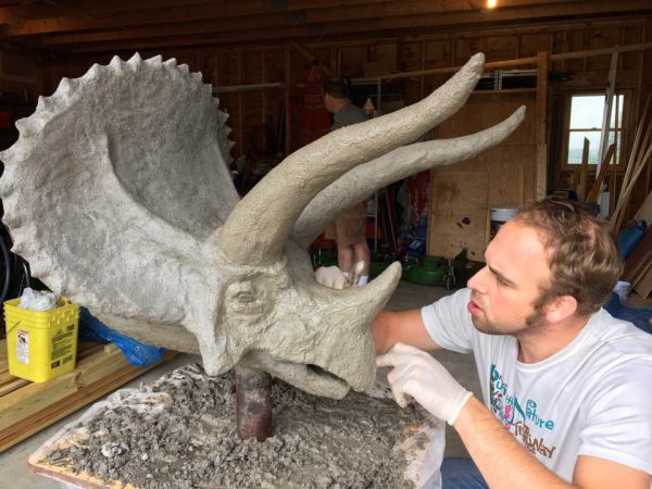 Applying the final textures to the ferrocement triceratops head.