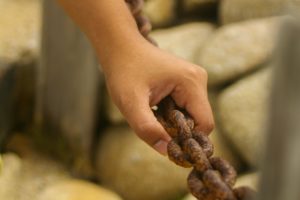 Hand holding chain Asilomar State Beach